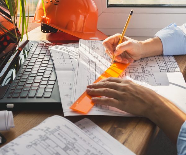 architect design working drawing sketch plans blueprints and making architectural construction model in home